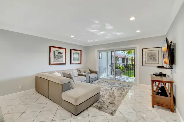 a living room with furniture and large window