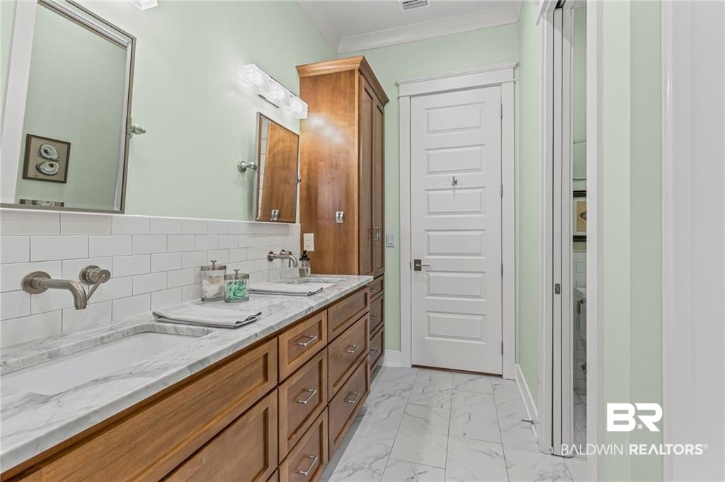 2730 Gator Road Mobile, AL 36605 - Photo 21 of 42 Full bathroom with double vanity and light marble finish flooring