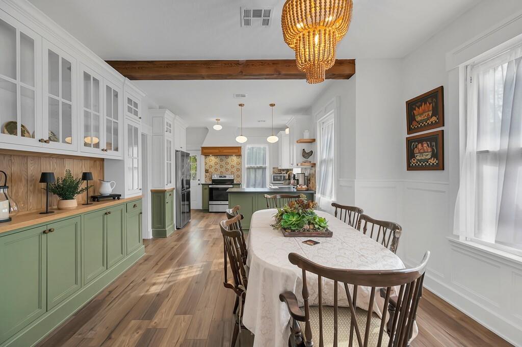 2612 Fort Avenue Waco, TX 76707 - Photo 12 of 40 a kitchen with stainless steel appliances kitchen island granite countertop a table chairs in it and wooden floors