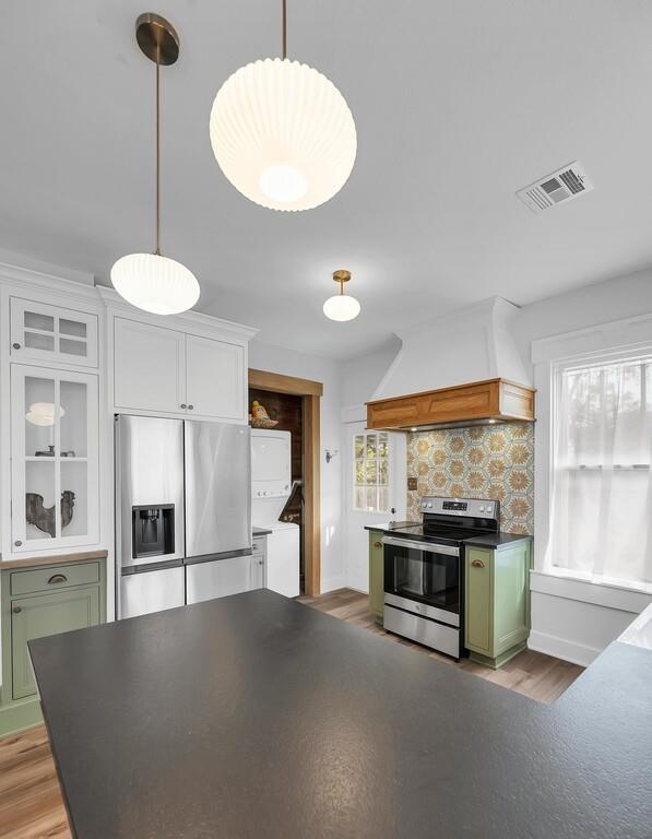 2612 Fort Avenue Waco, TX 76707 - Photo 19 of 40 a view of a kitchen with a stove wooden cabinets and a floor to ceiling window