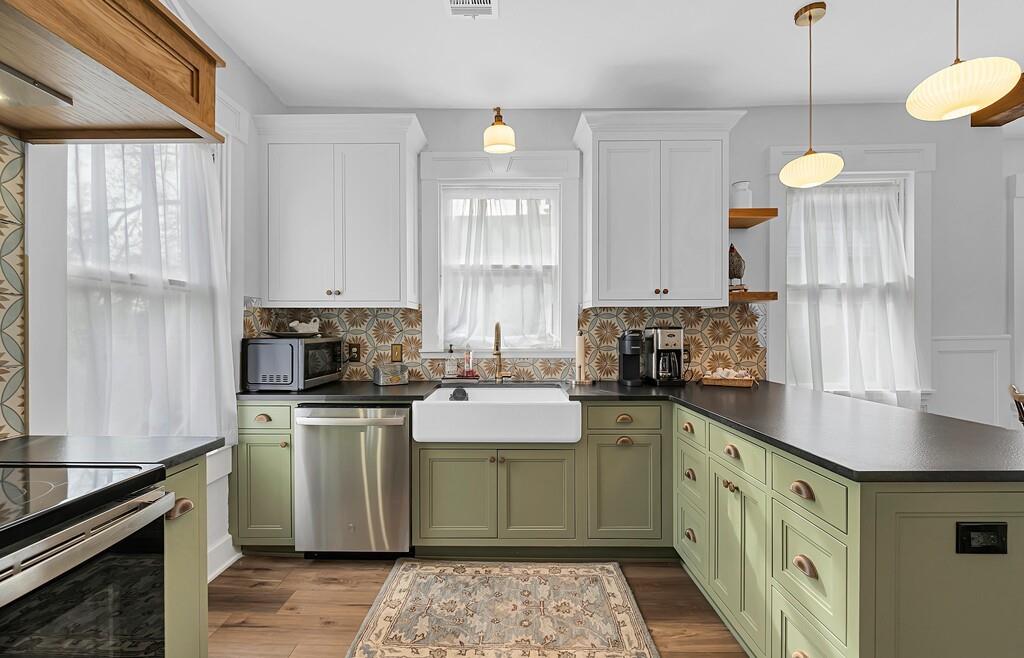 2612 Fort Avenue Waco, TX 76707 - Photo 20 of 40 a kitchen with stainless steel appliances a sink a stove a refrigerator cabinets and a window