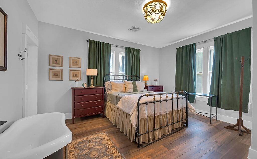 2612 Fort Avenue Waco, TX 76707 - Photo 27 of 40 a bedroom with a bed and a chandelier