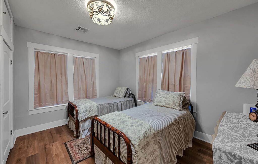 2612 Fort Avenue Waco, TX 76707 - Photo 34 of 40 a bedroom with a bed and a chandelier