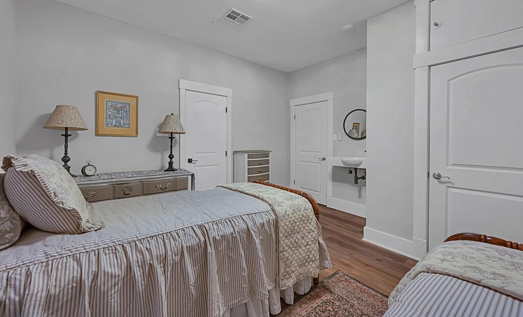 2612 Fort Avenue Waco, TX 76707 - Photo 36 of 40 a bedroom with a bed and wooden floor