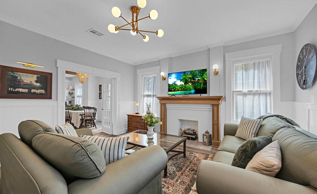 2612 Fort Avenue Waco, TX 76707 - Photo 4 of 40 a living room with furniture a fireplace and a flat screen tv