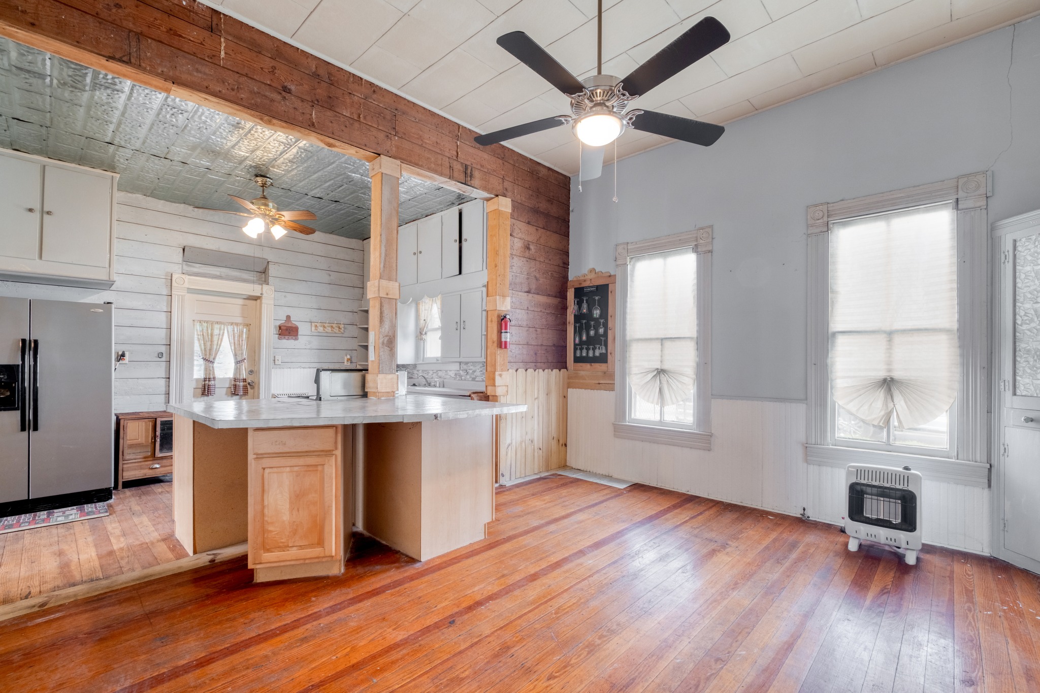 300 Rio Grande Street Granger, TX 76530 - Photo 11 of 25 a large kitchen with cabinets and wooden floor