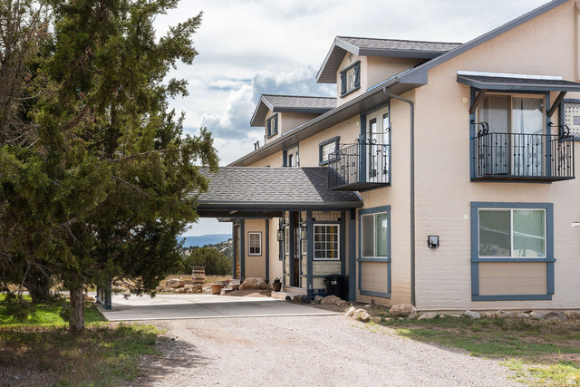 11550 Pigeon Hollow Road Spring City, UT 84662 - Photo 18 of 85 Multi-level exterior with stucco finish, multiple balconies with wrought iron railings, and a covered entryway