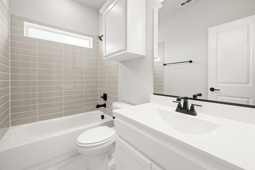 620 Red Maple Road Waxahachie, TX 75165 - Photo 12 of 40 a bathroom with a sink a toilet and shower