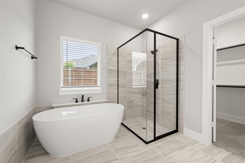 620 Red Maple Road Waxahachie, TX 75165 - Photo 18 of 40 a bathroom with a bathtub and a shower