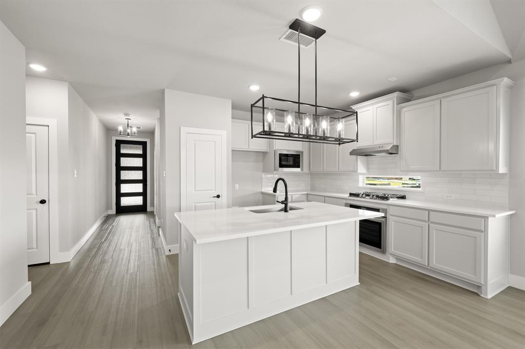 620 Red Maple Road Waxahachie, TX 75165 - Photo 19 of 40 a kitchen with stainless steel appliances granite countertop a sink stove and refrigerator
