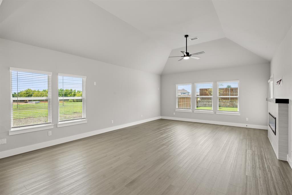 620 Red Maple Road Waxahachie, TX 75165 - Photo 24 of 40 a view of an empty room with wooden floor and a window