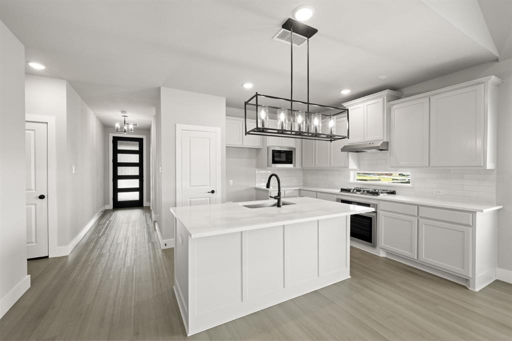 620 Red Maple Road Waxahachie, TX 75165 - Photo 3 of 40 a kitchen with stainless steel appliances granite countertop a sink stove and refrigerator