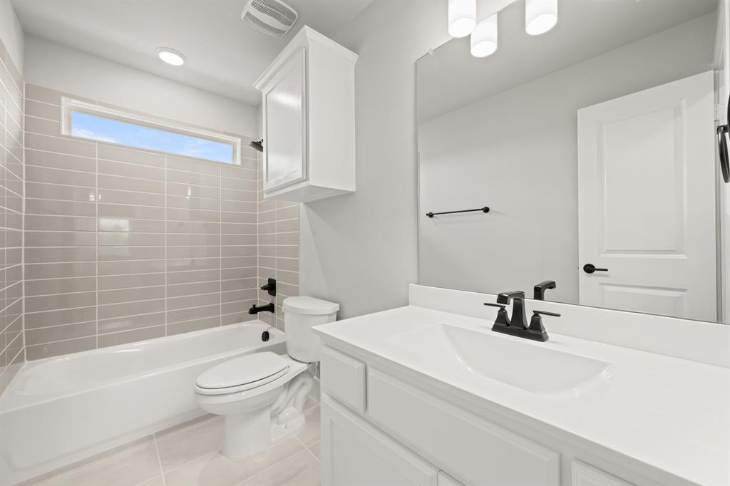 620 Red Maple Road Waxahachie, TX 75165 - Photo 36 of 40 a bathroom with a sink a toilet and shower