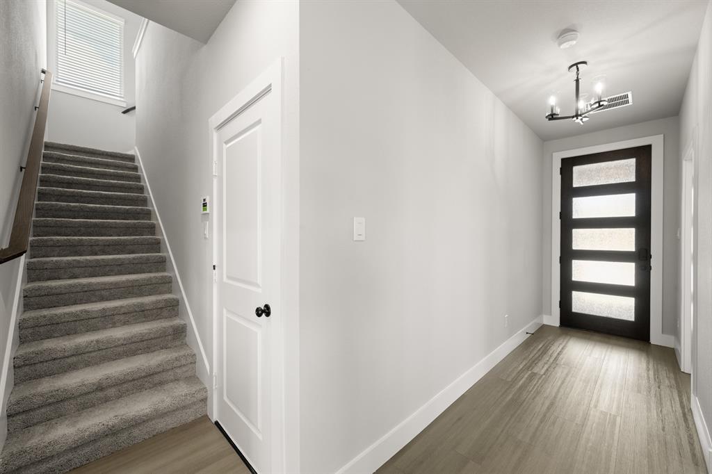 620 Red Maple Road Waxahachie, TX 75165 - Photo 8 of 40 wooden floor in an empty room with a window