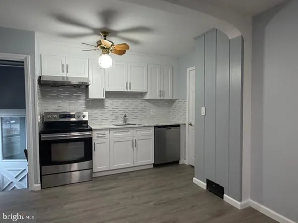 a kitchen with a sink and a stove top oven