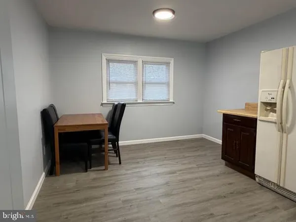 a view of a workspace with furniture and wooden floor