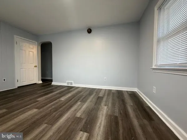 a view of an empty room and wooden floor