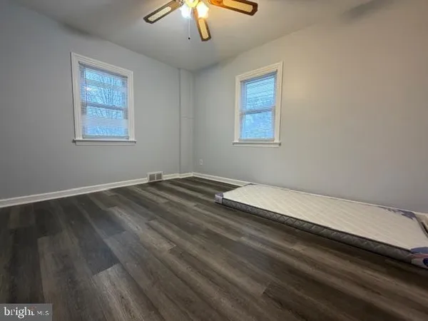 a room with a bed and a chandelier fan