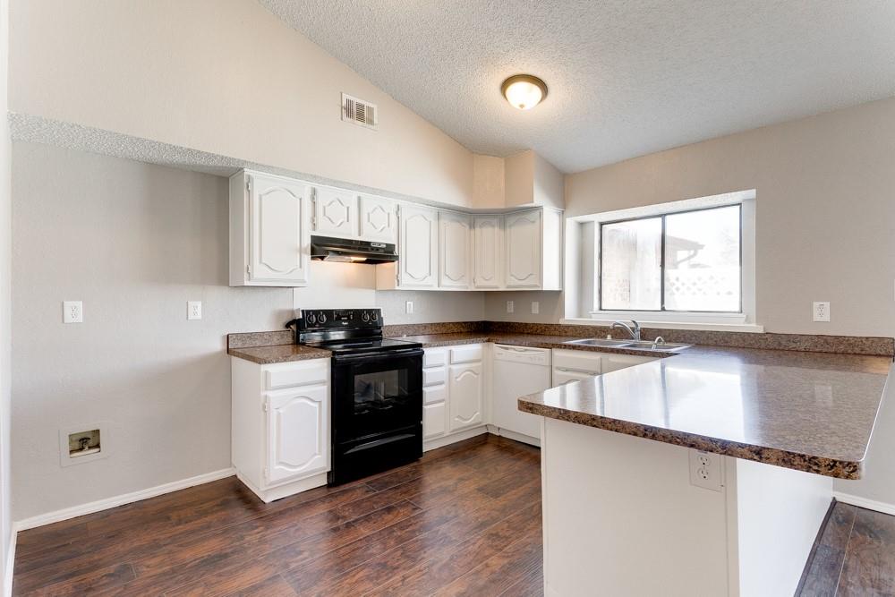 9421 Shipman Street Rowlett, TX 75088 - Photo 12 of 29 a kitchen with a sink stove top oven and cabinets