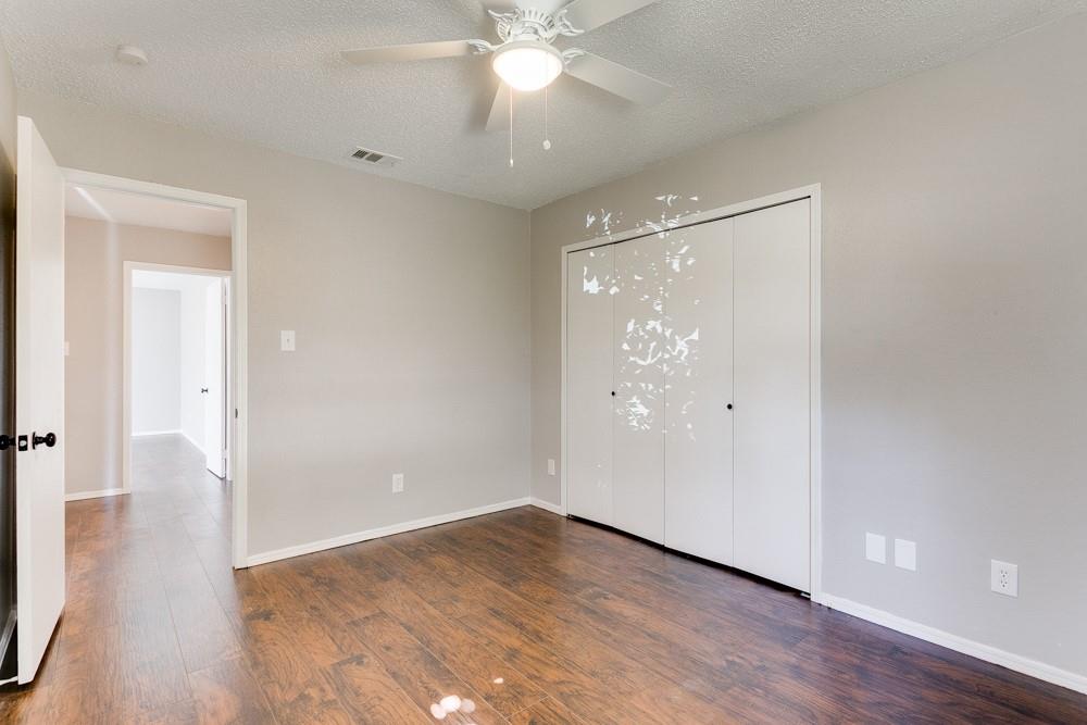9421 Shipman Street Rowlett, TX 75088 - Photo 16 of 29 a view of an empty room with wooden floor and a ceiling fan