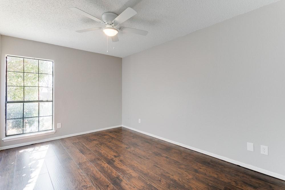9421 Shipman Street Rowlett, TX 75088 - Photo 17 of 29 an empty room with wooden floor and windows