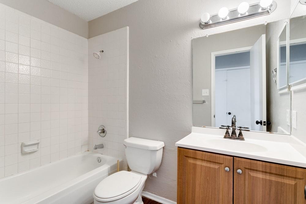 9421 Shipman Street Rowlett, TX 75088 - Photo 20 of 29 a bathroom with a sink toilet vanity and shower