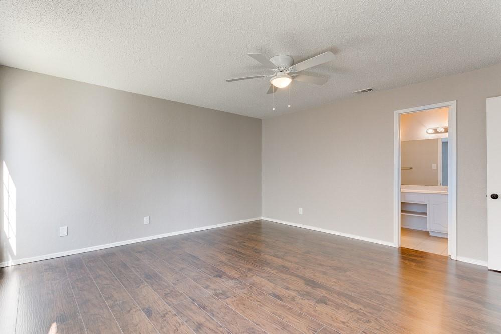 9421 Shipman Street Rowlett, TX 75088 - Photo 24 of 29 an empty room with wooden floor and ceiling fan