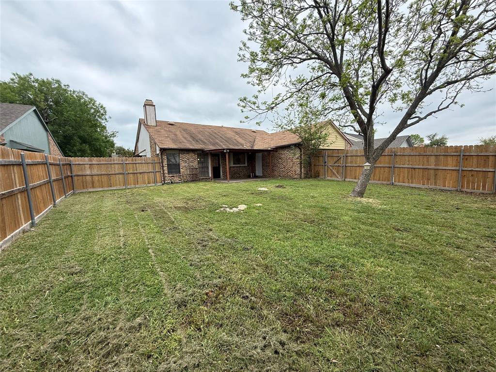 9421 Shipman Street Rowlett, TX 75088 - Photo 27 of 29 a large house with a big yard and large trees