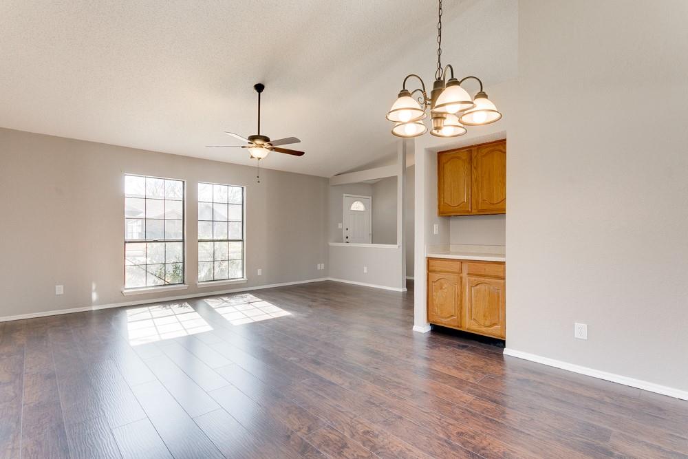 9421 Shipman Street Rowlett, TX 75088 - Photo 4 of 29 a view of an empty room with wooden floor and a window