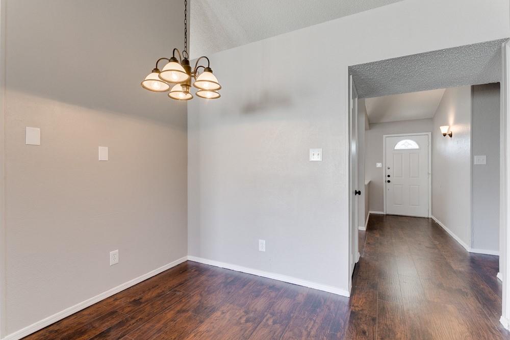 9421 Shipman Street Rowlett, TX 75088 - Photo 6 of 29 a view of an empty room with wooden floor and a window