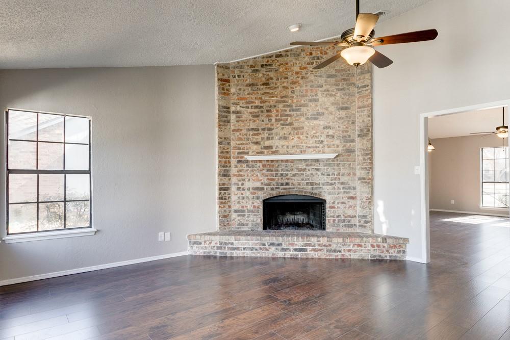 9421 Shipman Street Rowlett, TX 75088 - Photo 10 of 29 wooden floor fireplace and windows in an empty room