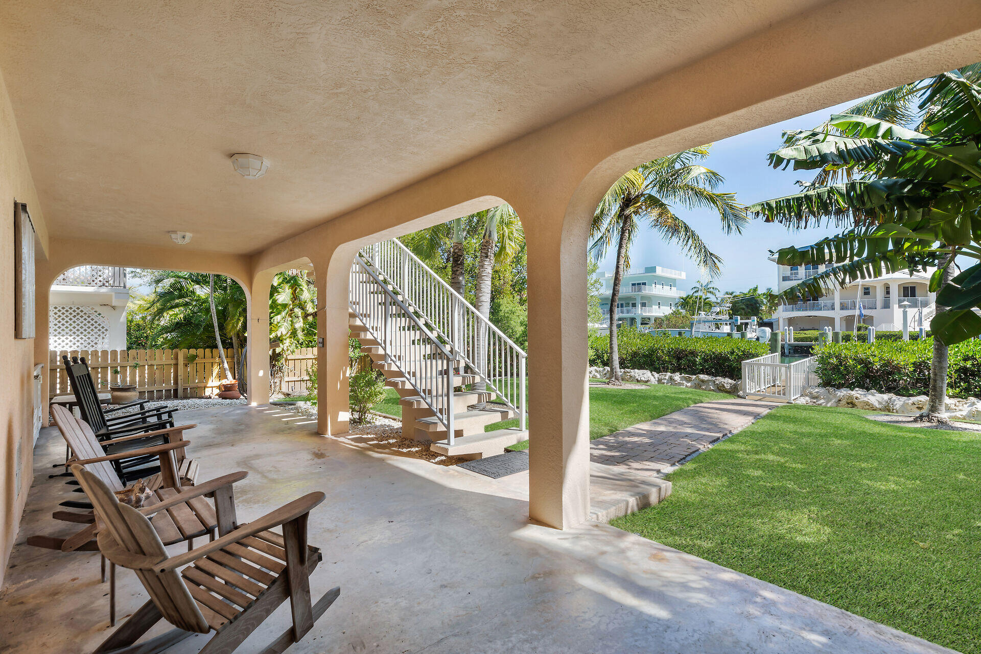 845 Copa D Oro Marathon, FL 33050 - Photo 12 of 41 a view of a patio with a dining table and chairs next to a yard