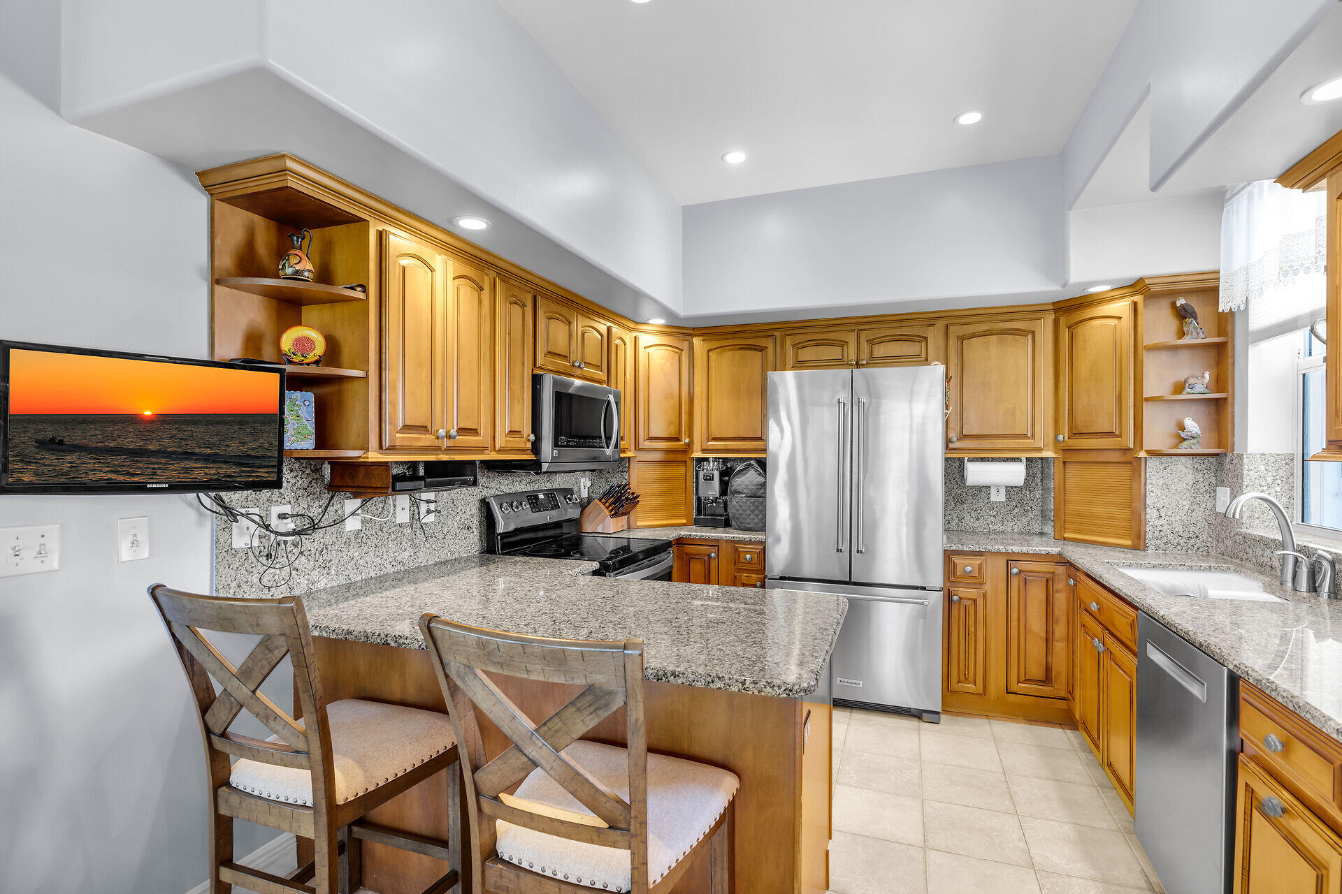 845 Copa D Oro Marathon, FL 33050 - Photo 21 of 41 a kitchen with stainless steel appliances granite countertop a refrigerator a stove a sink a dining table and chairs with wooden floor