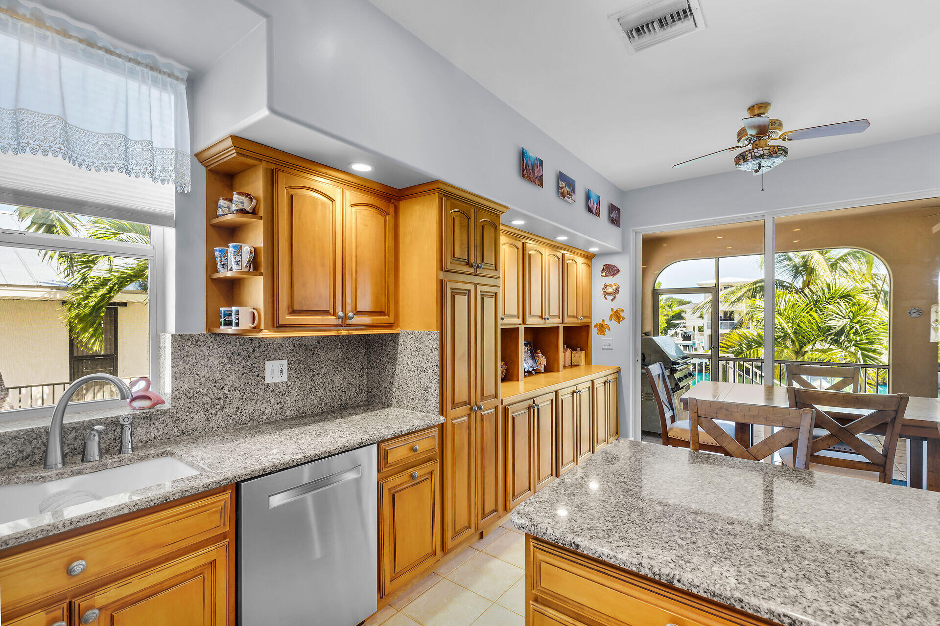 845 Copa D Oro Marathon, FL 33050 - Photo 22 of 41 a kitchen with stainless steel appliances granite countertop sink stove and large window