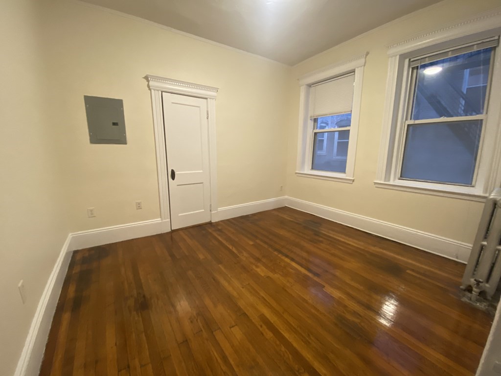 327 Huntington Avenue, Unit 31 Boston, MA 02115 - Photo 3 of 3 a view of an empty room with wooden floor and a window