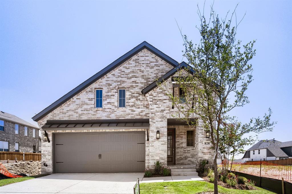 828 Stone Grv Road Lavon, TX 75166 - Photo 1 of 27 Contemporary home featuring a light-colored brick exterior, dark asphalt shingle roof, and a two-car garage with a dark gray door