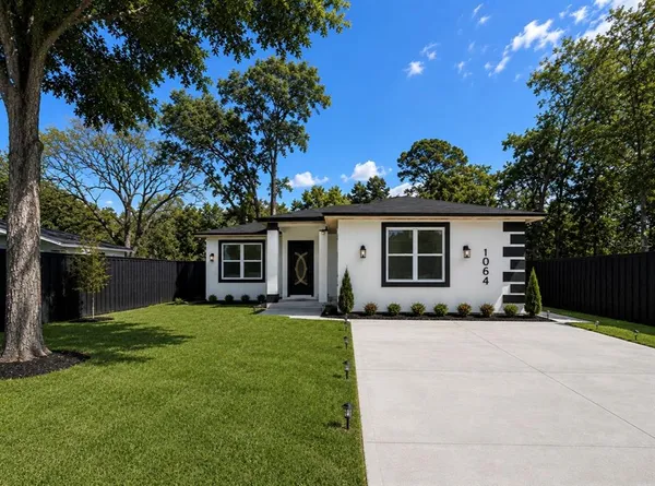 a front view of house with yard outdoor seating and green space