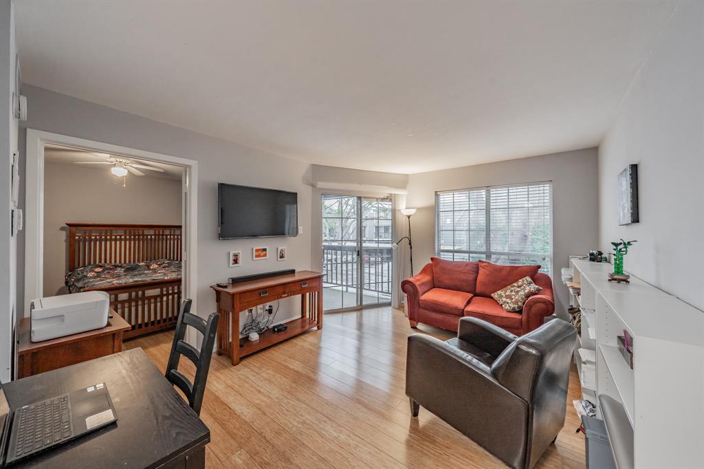 Living room with light hardwood / wood-style flooring and ceiling fan