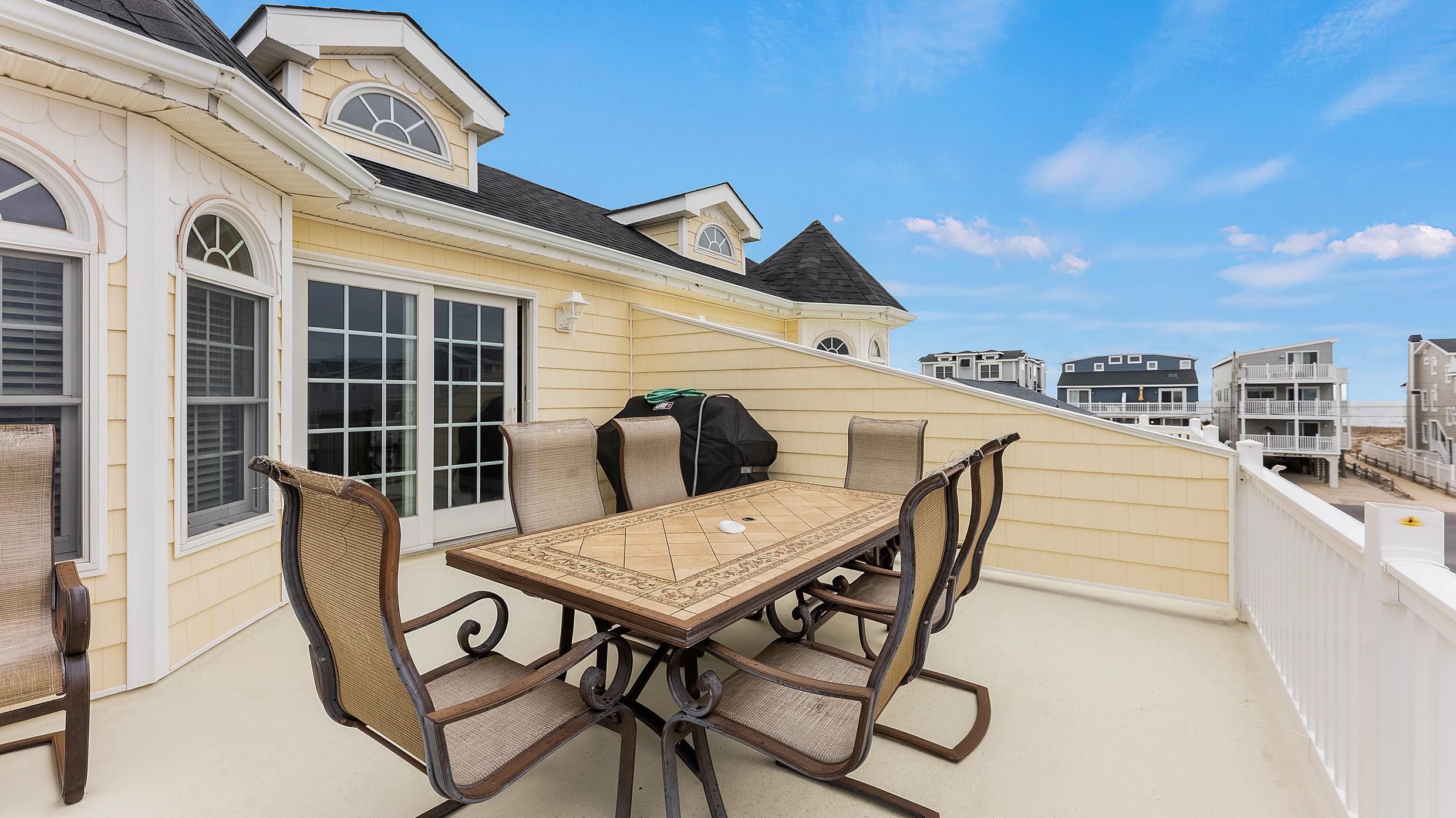9 78th Street, Unit WEST Sea Isle City, NJ 08243 - Photo 2 of 24 a view of a roof deck with furniture