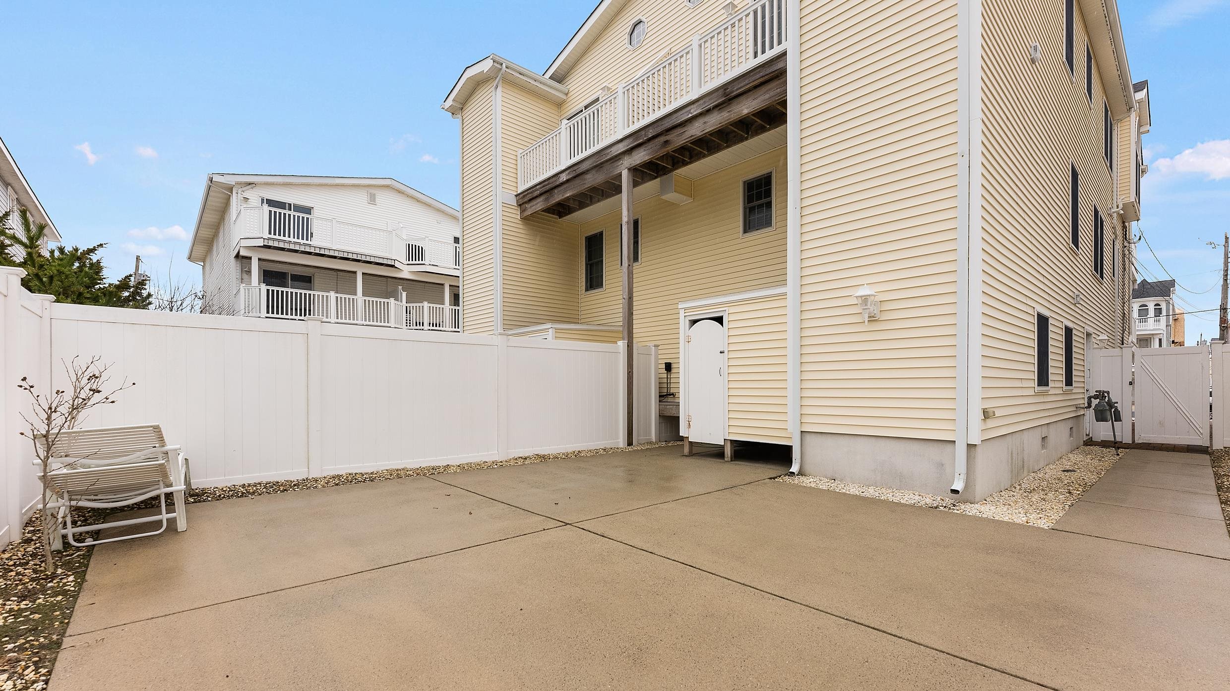 9 78th Street, Unit WEST Sea Isle City, NJ 08243 - Photo 24 of 24 a view of a house with a barbeque and wooden stairs