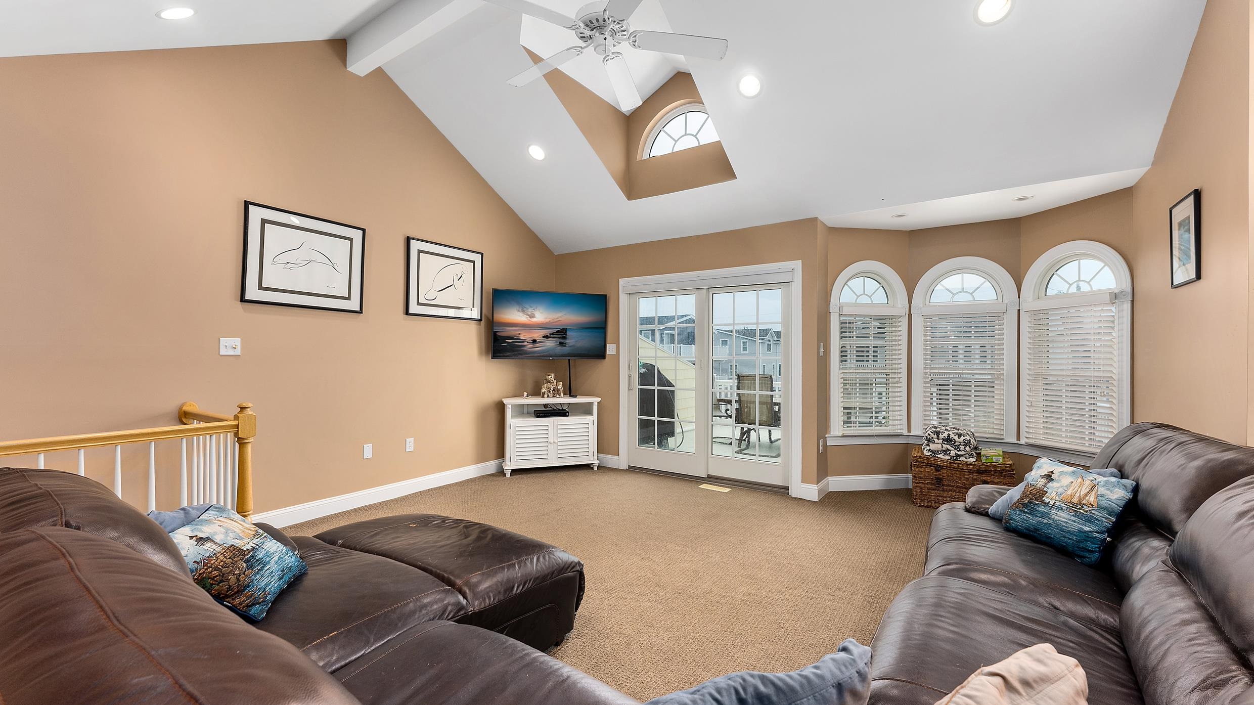 9 78th Street, Unit WEST Sea Isle City, NJ 08243 - Photo 3 of 24 a living room with furniture and a flat screen tv