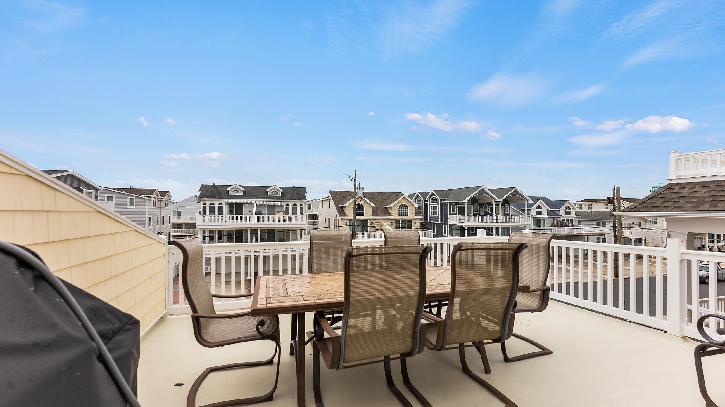 9 78th Street, Unit WEST Sea Isle City, NJ 08243 - Photo 9 of 24 a view of a balcony with chairs