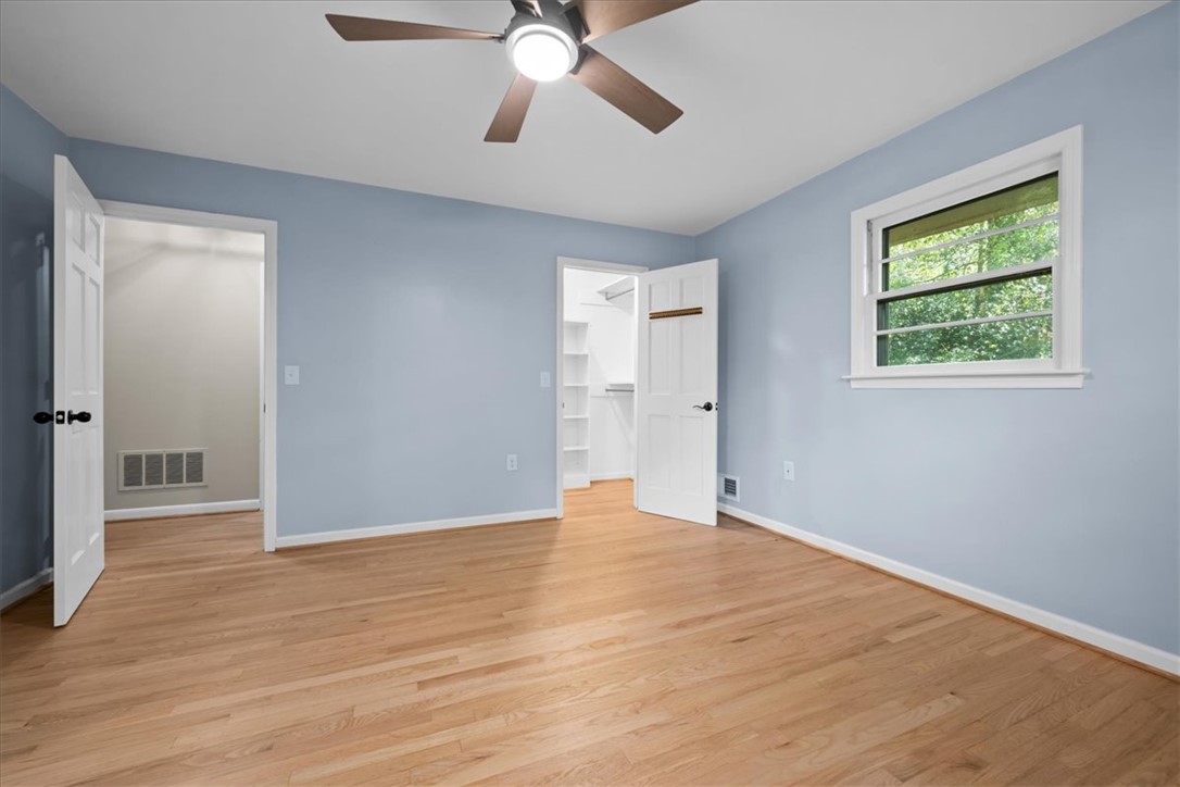 103 Satula Lane Clemson, SC 29631 - Photo 30 of 50 This spacious bedroom offers serene views and boasts beautiful hardwood flooring throughout.