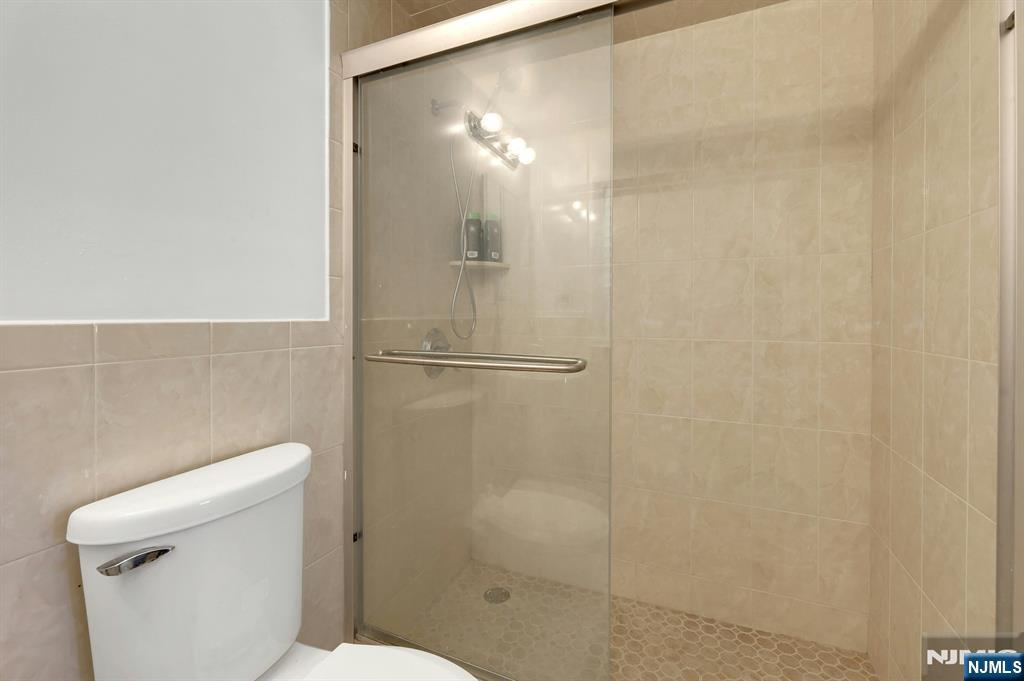 20 Blue Hill Road Norwood, NJ 07648 - Photo 41 of 49 a bathroom with a shower and a toilet
