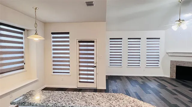 a view of a room with a window and wooden floor