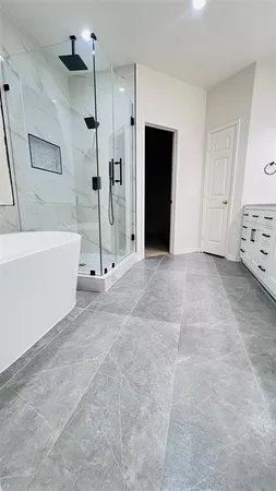 a view of a room with a ceiling fan and shower