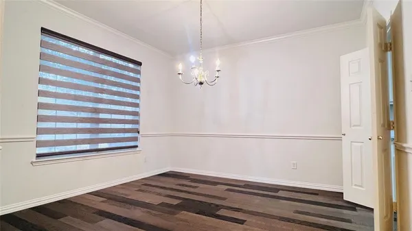a view of a room with wooden floor and staircase