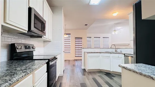 a kitchen with stainless steel appliances granite countertop a sink stove and oven