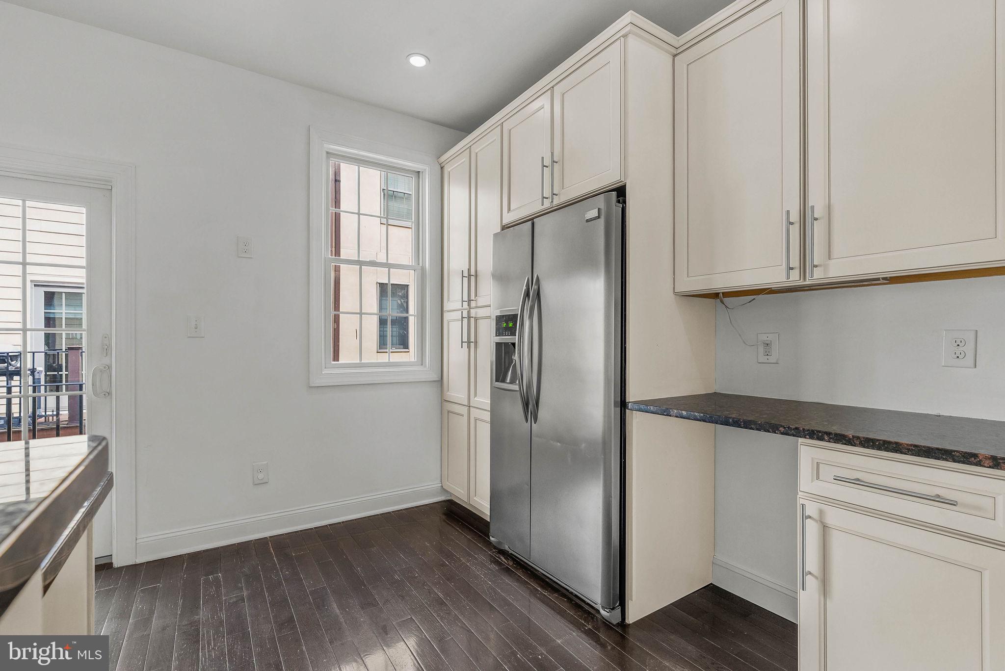 1015 North 3rd Street, Unit H Philadelphia, PA 19123 - Photo 9 of 27 a kitchen with stainless steel appliances granite countertop a refrigerator and a stove top oven