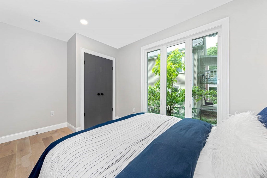 36-38 Johnswood Road Boston, MA 02131 - Photo 13 of 42 a bedroom with a bed and a large window